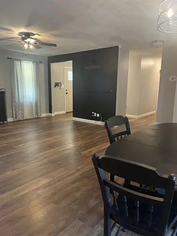 a dining room with furniture and wooden floor