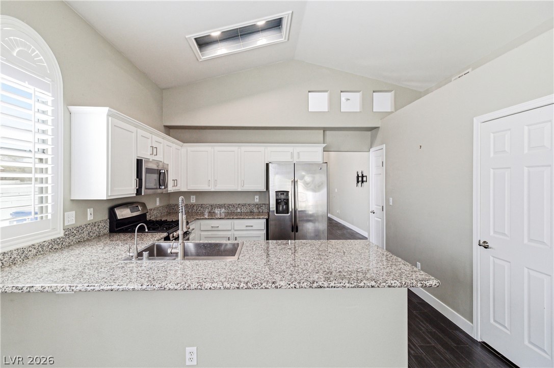 9523 Observer Street Las Vegas, NV 89123 - Photo 13 of 42 Culinary adventures await in this naturally illuminated kitchen with ample counter space and a vaulted ceiling.