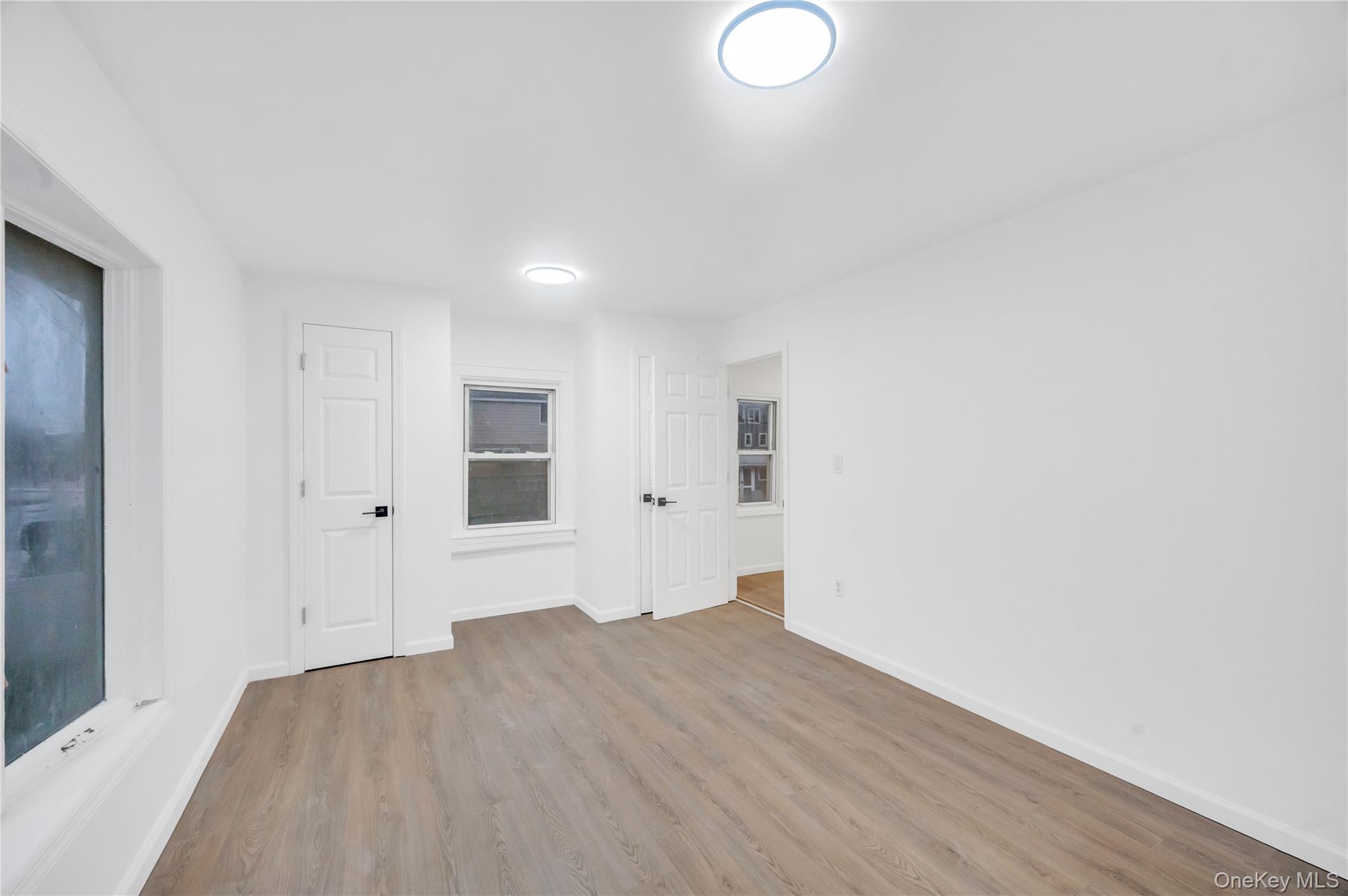 21 Van Brunt Road Queens, NY 11693 - Photo 11 of 17 Unfurnished room featuring wood finished floors and baseboards