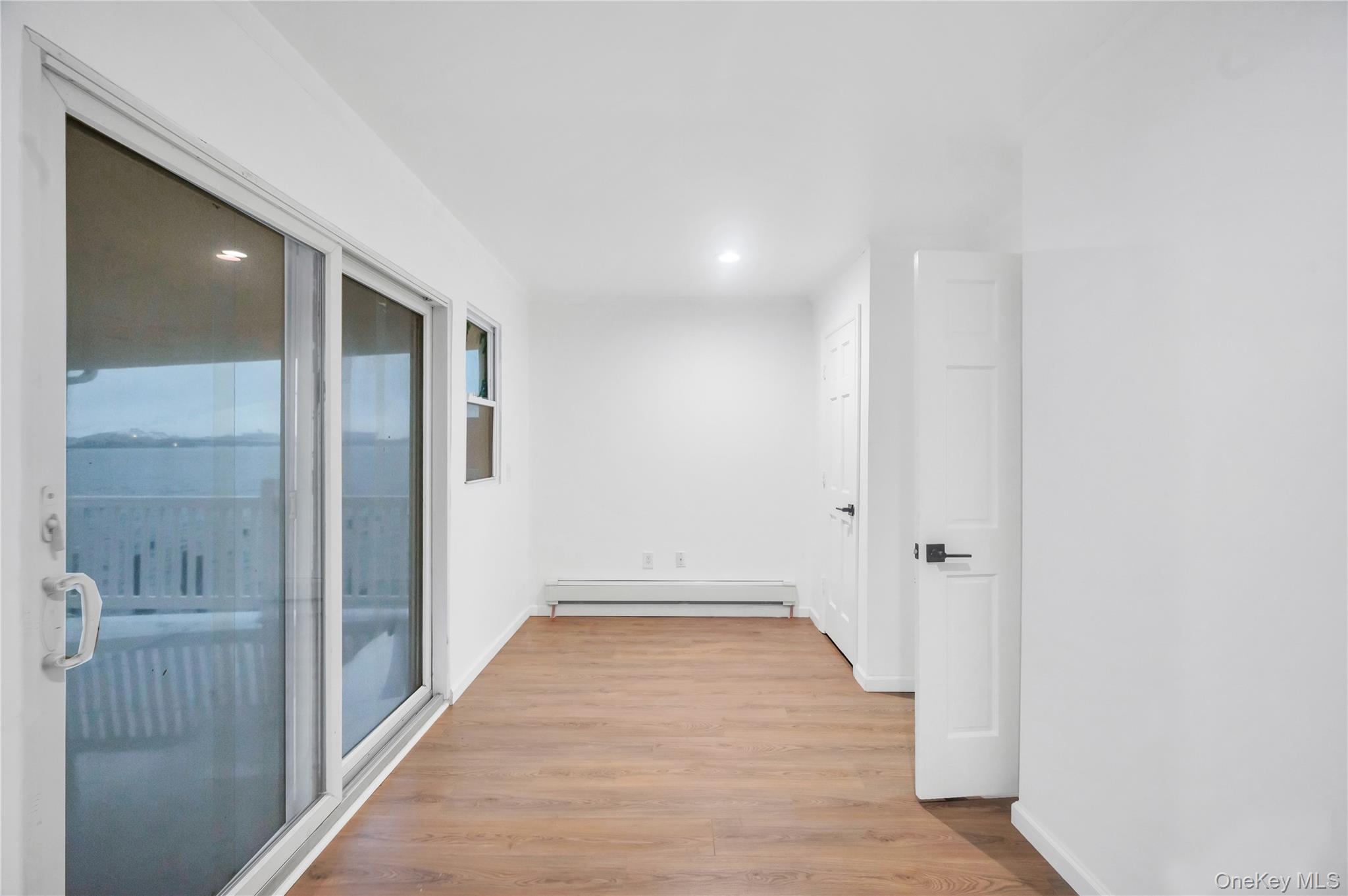 21 Van Brunt Road Queens, NY 11693 - Photo 12 of 17 Hall featuring light wood-type flooring, baseboard heating, and recessed lighting