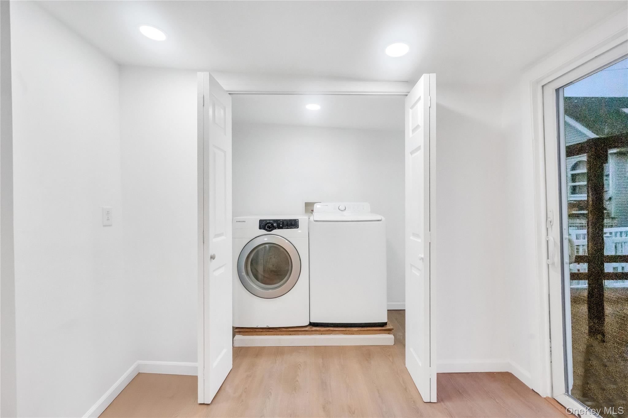 21 Van Brunt Road Queens, NY 11693 - Photo 14 of 17 Laundry room with light wood finished floors, washer and clothes dryer, and recessed lighting