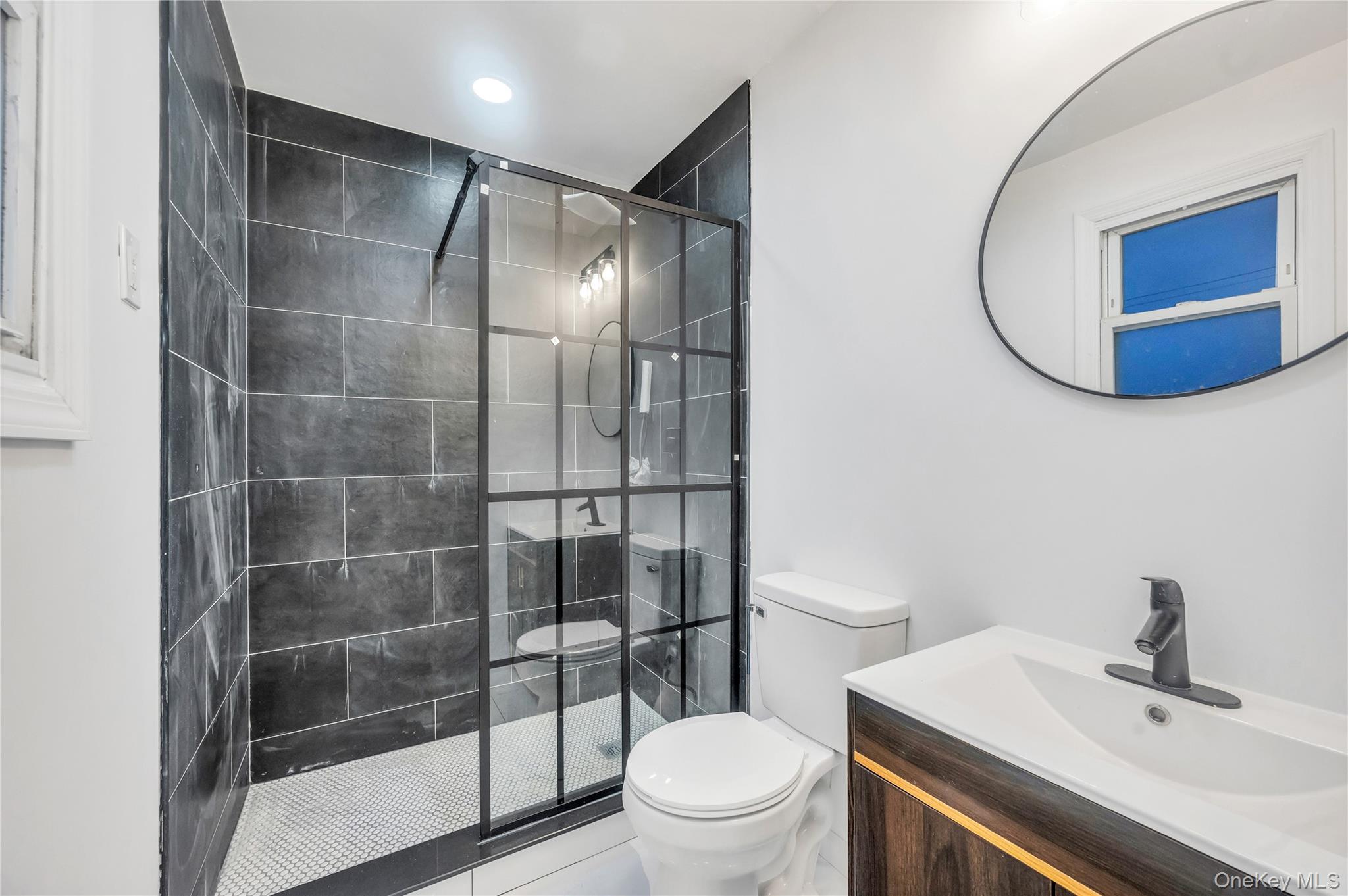 21 Van Brunt Road Queens, NY 11693 - Photo 8 of 17 Full bath featuring vanity, a walk in shower, and tile patterned floors