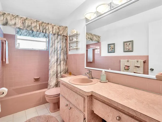 a spacious bedroom with a large bed and a dresser