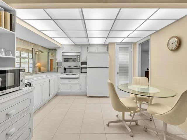 a kitchen with cabinets and chairs