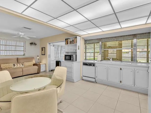 a living room with furniture a fireplace and a large window