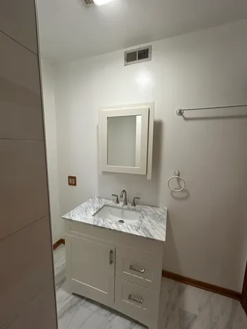 a bathroom with a double vanity sink and mirror