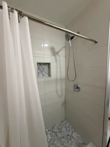 a bathroom with a shower and a sink