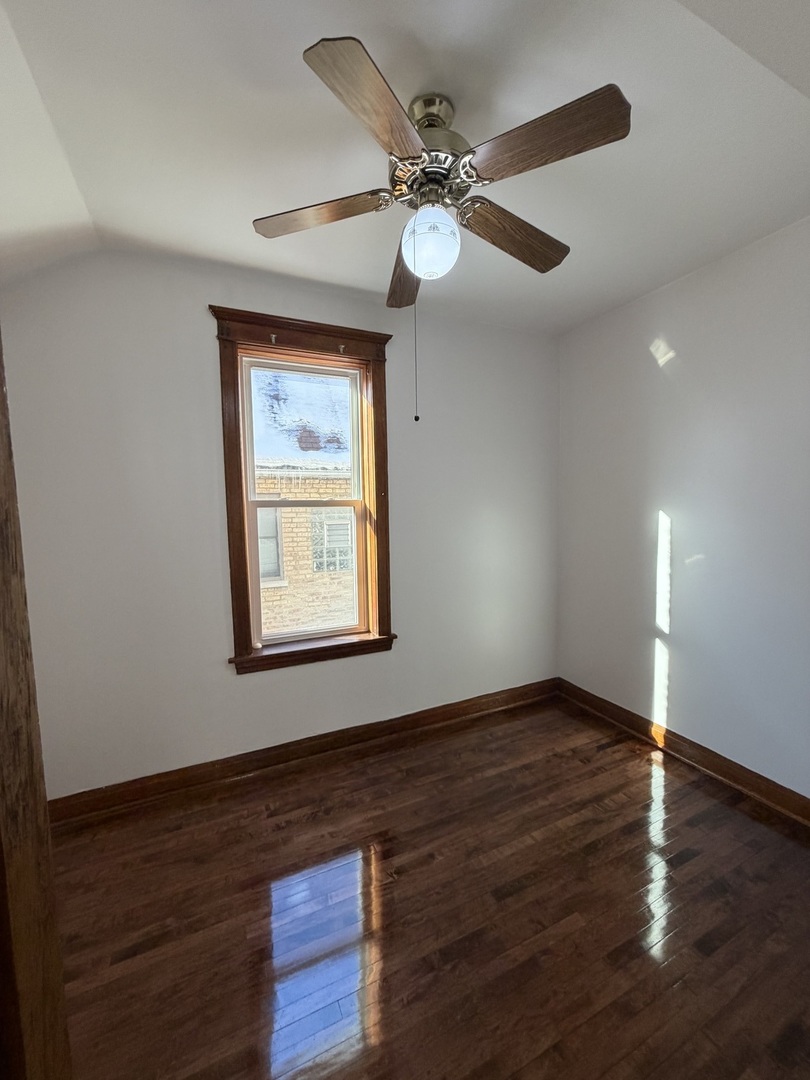 2624 West Walton Street, Unit 1 Chicago, IL 60622 - Photo 20 of 23 a view of an empty room with wooden floor and a window