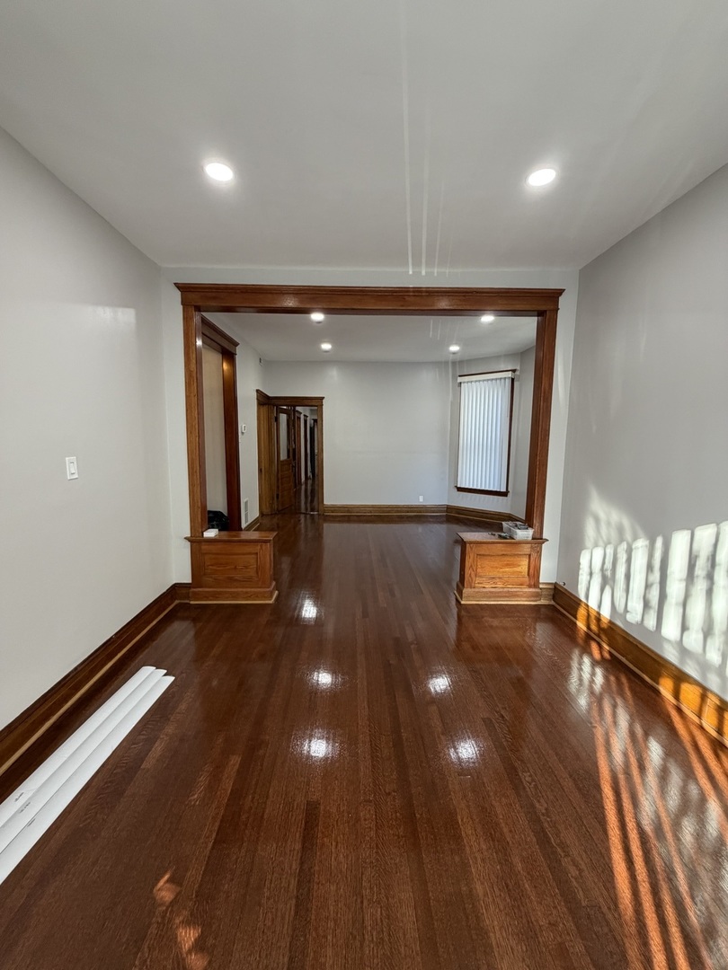 2624 West Walton Street, Unit 1 Chicago, IL 60622 - Photo 7 of 23 a view of an empty room with glass door and windows