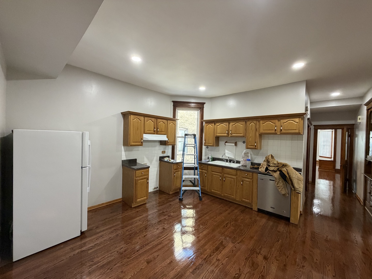 2624 West Walton Street, Unit 1 Chicago, IL 60622 - Photo 8 of 23 a kitchen with a wooden floor kitchen counter top space and stainless steel appliances
