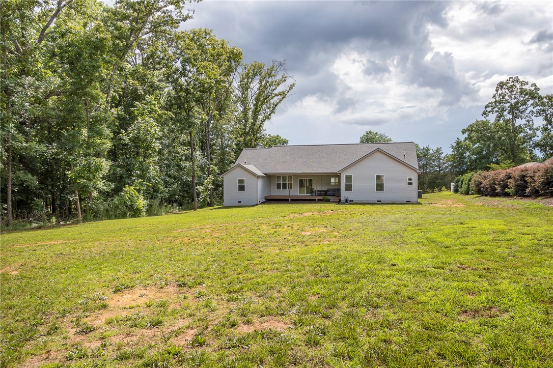 3080 McGee Road Iva, SC 29655 - Photo 42 of 49 A spacious yard provides ample room for outdoor activities, complementing the house's inviting rear deck.