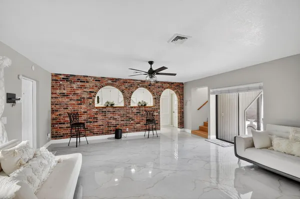 a view of a kitchen with a refrigerator and microwave