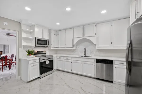 a view of a dining room with furniture and chandelier
