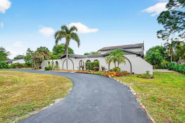a front view of a house with a yard and a garage
