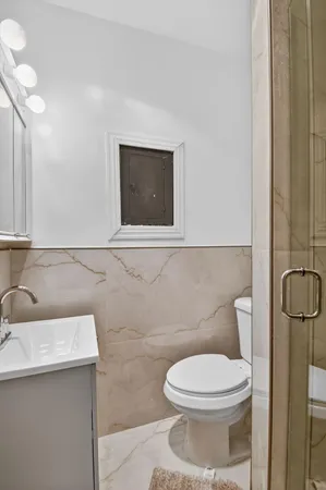 a bathroom with a sink a toilet and shower curtain