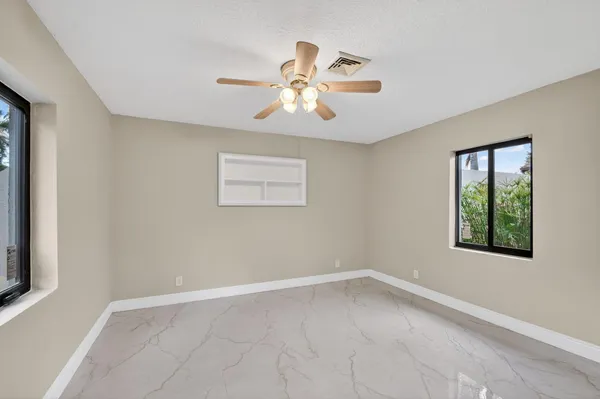 a view of a livingroom with a ceiling fan and window