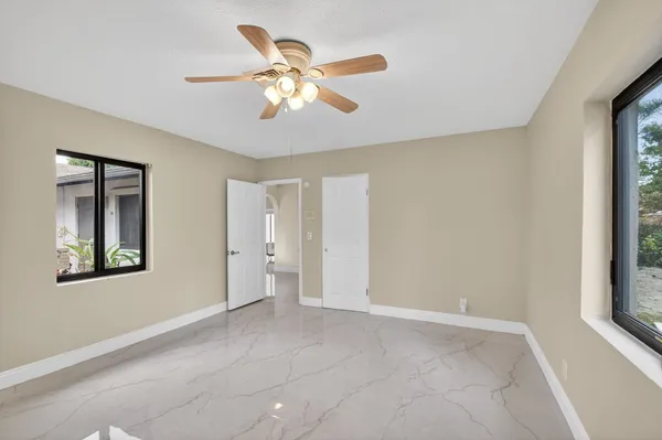a view of a livingroom with a ceiling fan and window