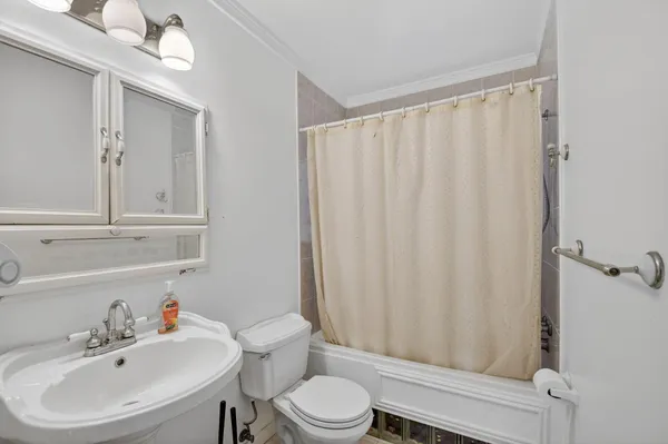 a bathroom with a toilet sink vanity and mirror