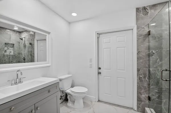 a bathroom with a tub sink and mirror