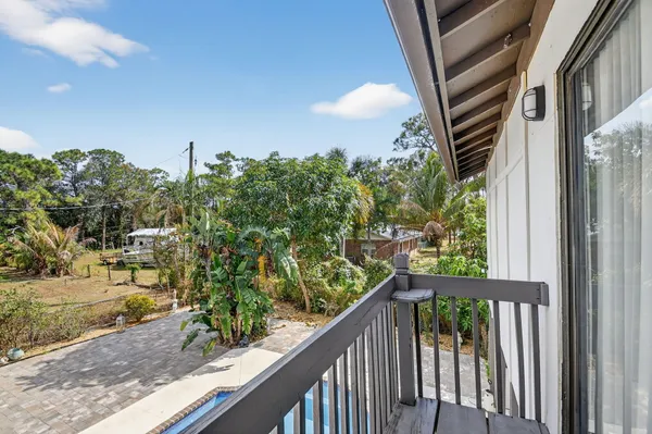 a view of a house with swimming pool and sitting area