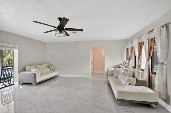 a bedroom with furniture and chandelier