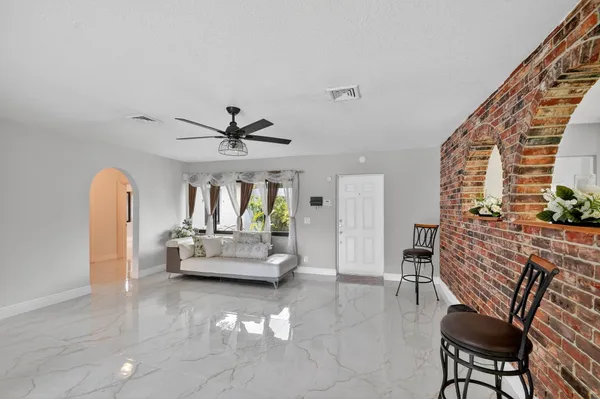 a kitchen with granite countertop white cabinets and stainless steel appliances