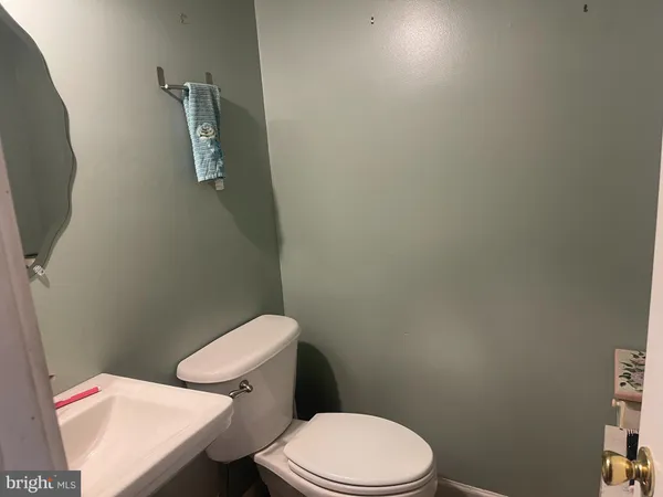 a white toilet sitting next to a small bathroom