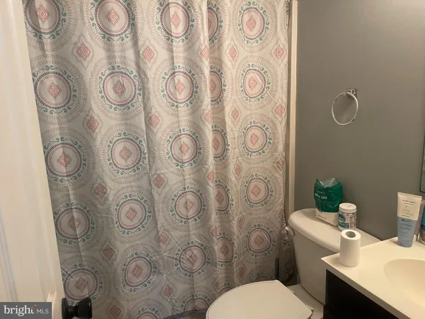 a white toilet sitting next to a bathroom sink