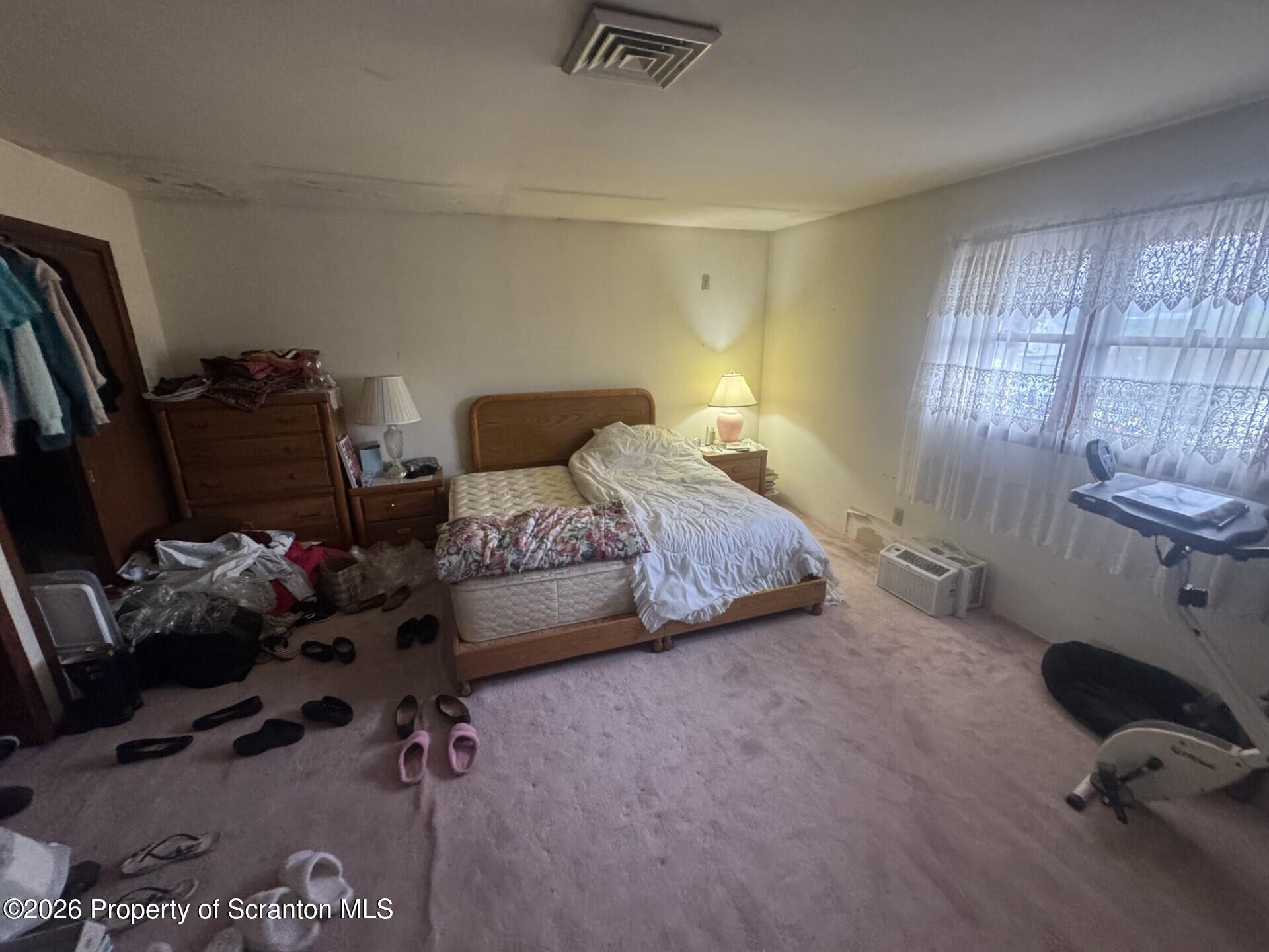 16 Maffett Street Plains, PA 18705 - Photo 10 of 19 a bedroom with a bed and a chandelier