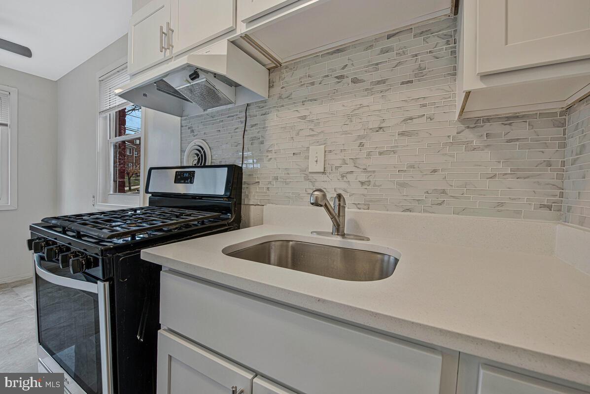 107 Joliet Street Washington, DC 20032 - Photo 12 of 52 a kitchen with cabinets and a stove top oven