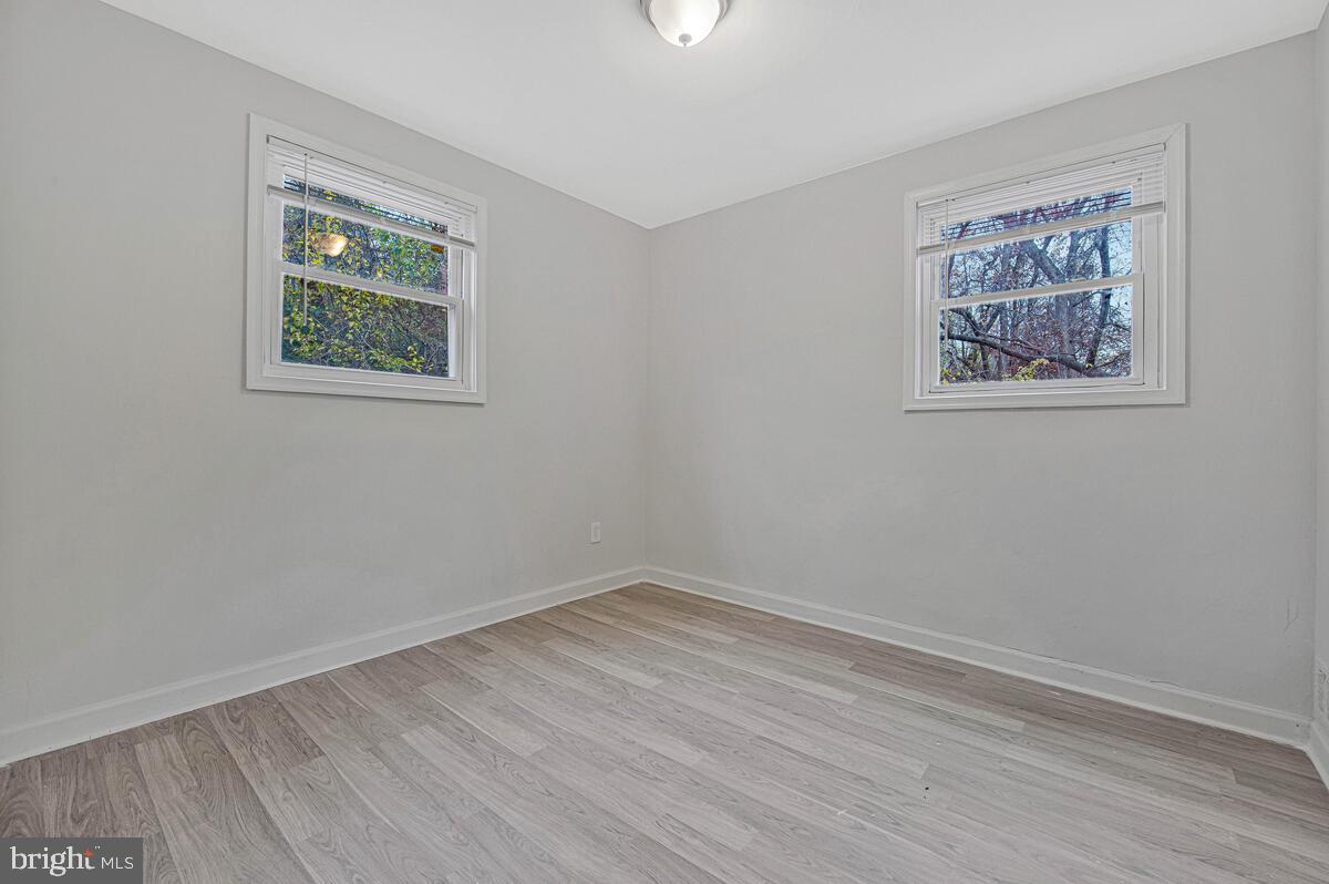 107 Joliet Street Washington, DC 20032 - Photo 14 of 52 a view of an empty room with wooden floor and window