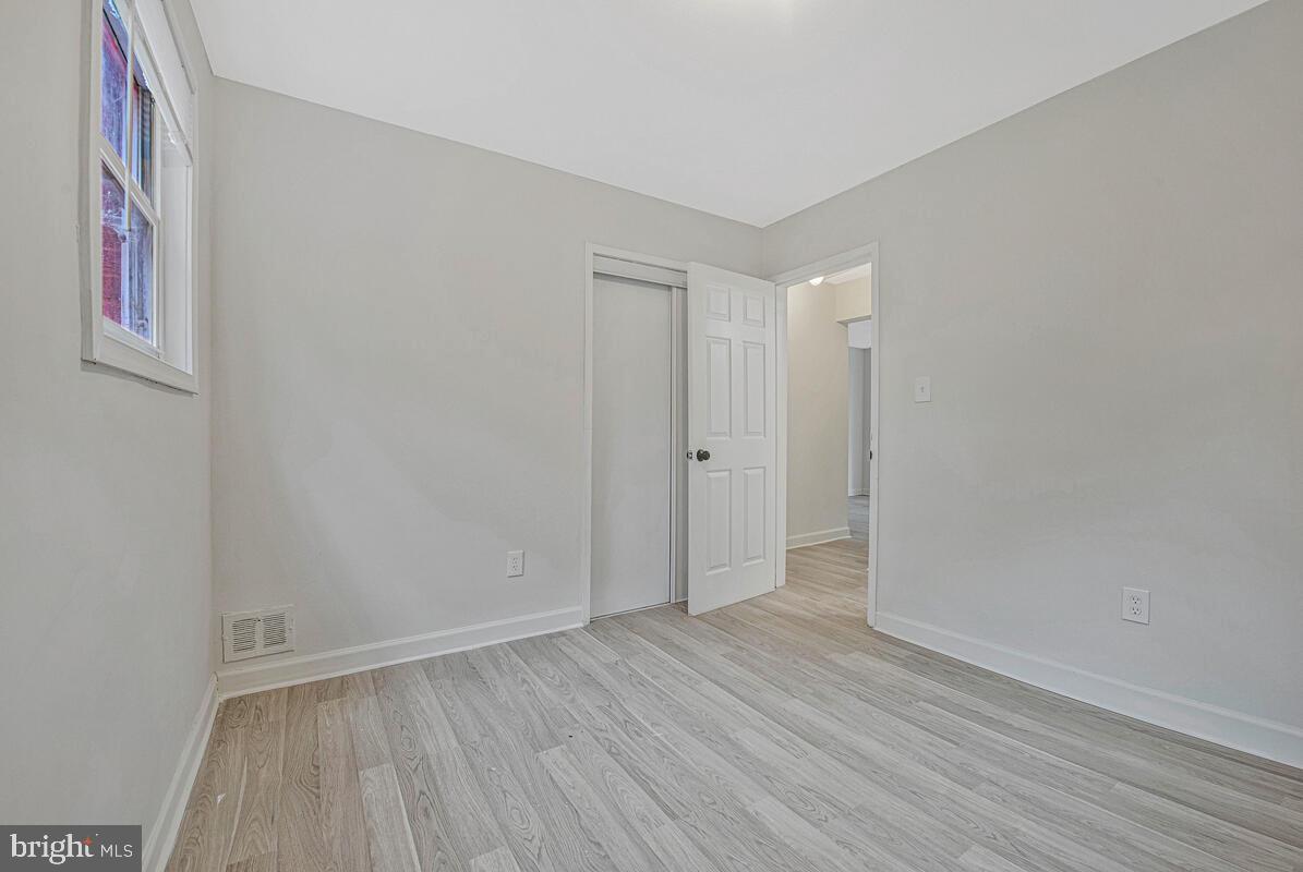 107 Joliet Street Washington, DC 20032 - Photo 15 of 52 a view of an empty room with wooden floor