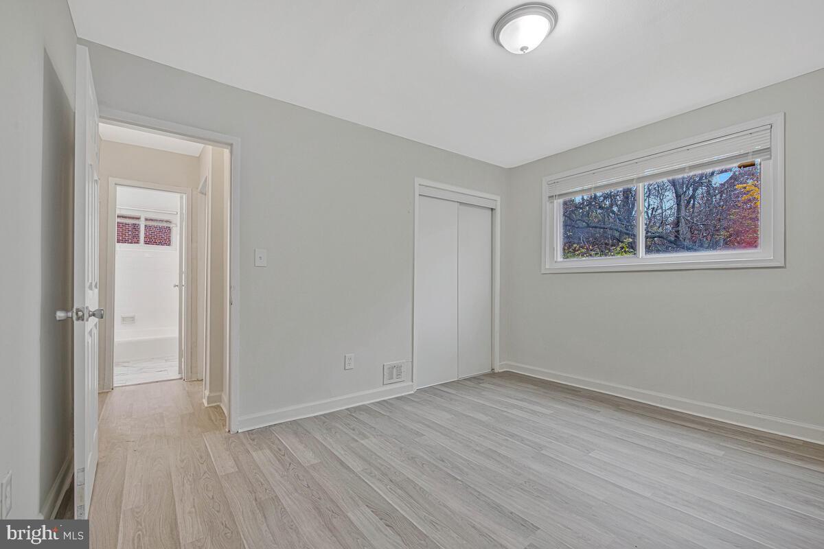 107 Joliet Street Washington, DC 20032 - Photo 18 of 52 an empty room with wooden floor and windows