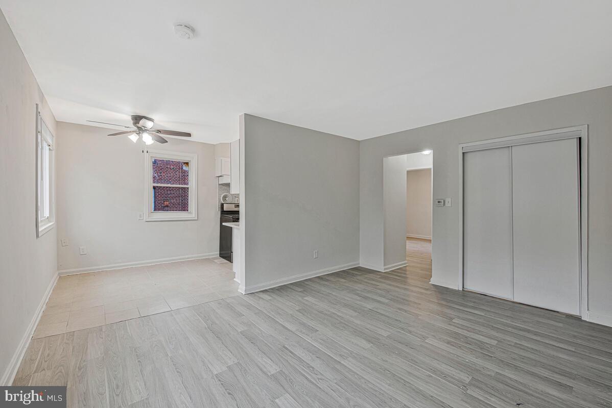 107 Joliet Street Washington, DC 20032 - Photo 24 of 52 a view of a livingroom with wooden floor and a ceiling fan