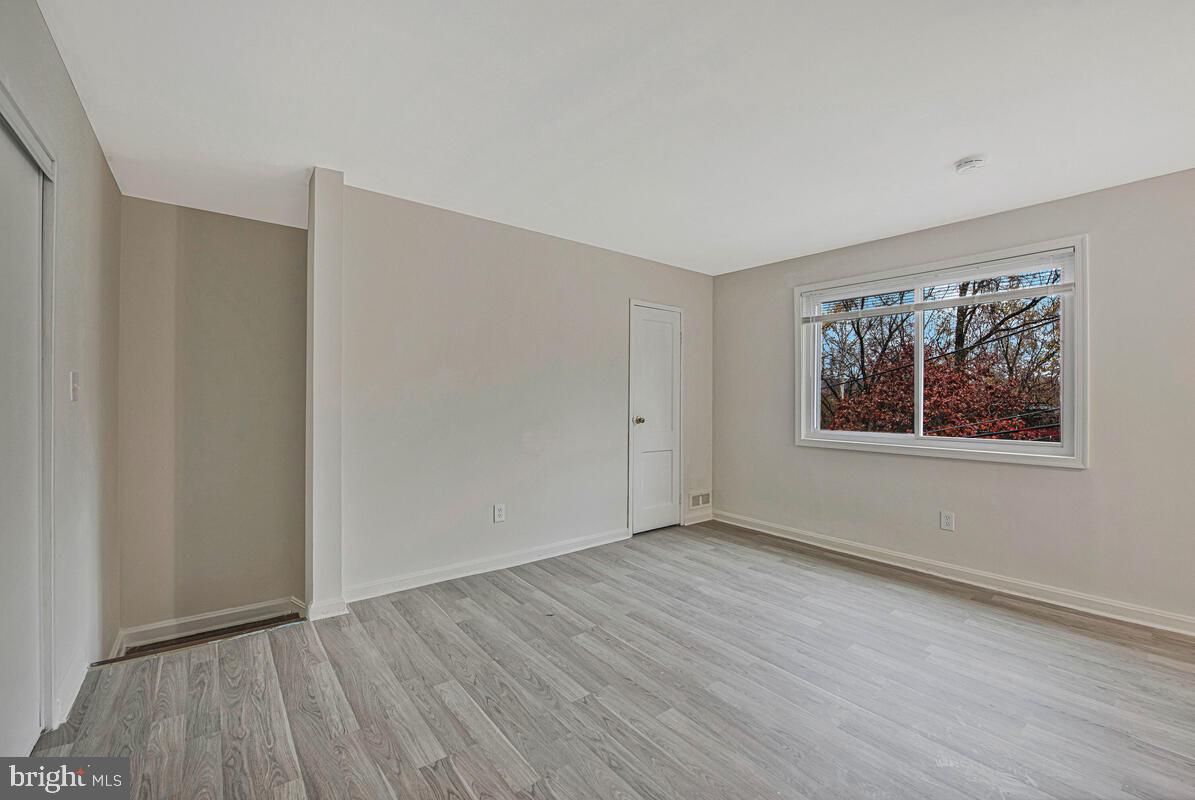 107 Joliet Street Washington, DC 20032 - Photo 25 of 52 a view of an empty room with wooden floor and a window