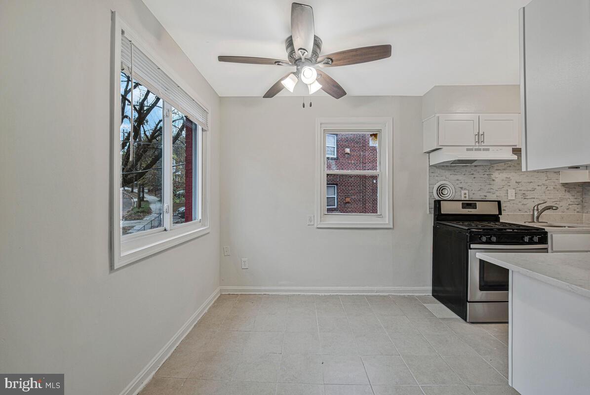 107 Joliet Street Washington, DC 20032 - Photo 26 of 52 a kitchen with stainless steel appliances granite countertop a stove a sink and a refrigerator