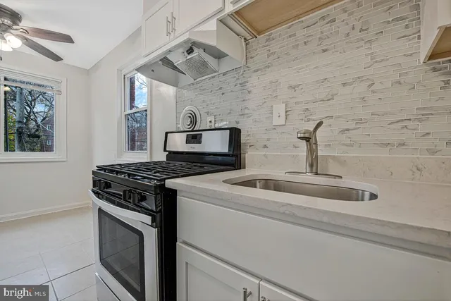 a kitchen with cabinets appliances and a window
