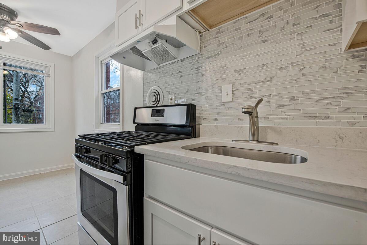 107 Joliet Street Washington, DC 20032 - Photo 30 of 52 a kitchen with stainless steel appliances granite countertop a stove and a refrigerator