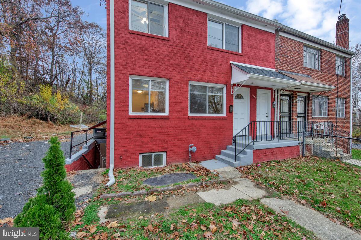 107 Joliet Street Washington, DC 20032 - Photo 3 of 52 a front view of brick house with a yard
