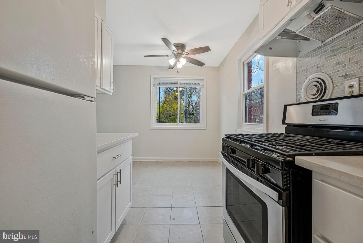 107 Joliet Street Washington, DC 20032 - Photo 31 of 52 a kitchen with cabinets appliances and a window