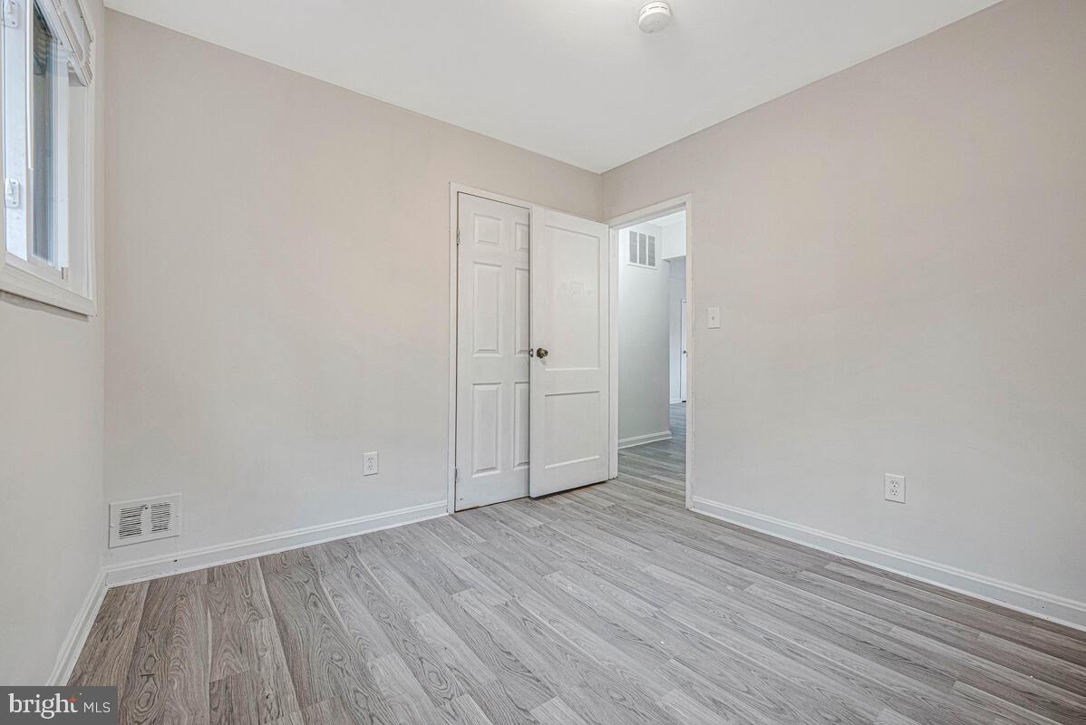107 Joliet Street Washington, DC 20032 - Photo 33 of 52 a view of an empty room with wooden floor