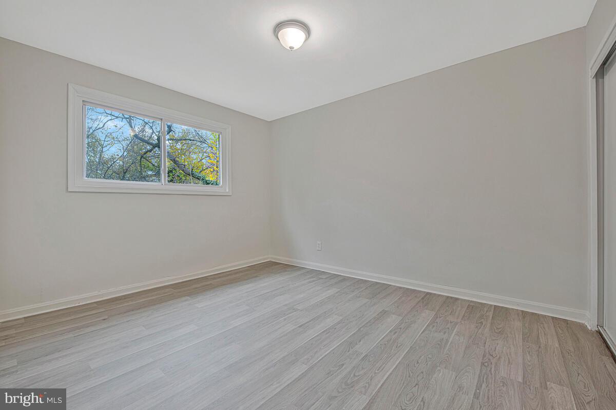 107 Joliet Street Washington, DC 20032 - Photo 34 of 52 wooden floor in an empty room with a window