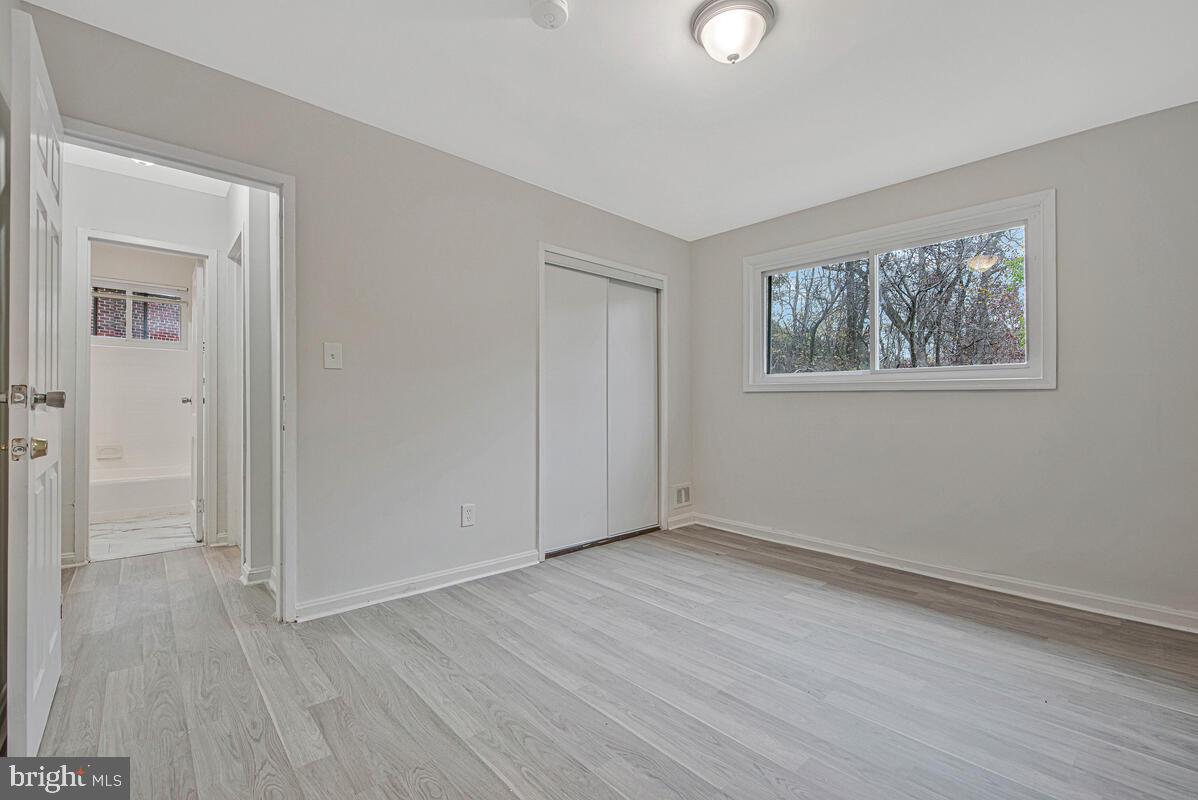 107 Joliet Street Washington, DC 20032 - Photo 36 of 52 a view of an empty room with wooden floor and a window