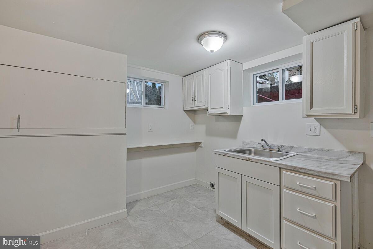 107 Joliet Street Washington, DC 20032 - Photo 43 of 52 a kitchen with a sink and cabinets