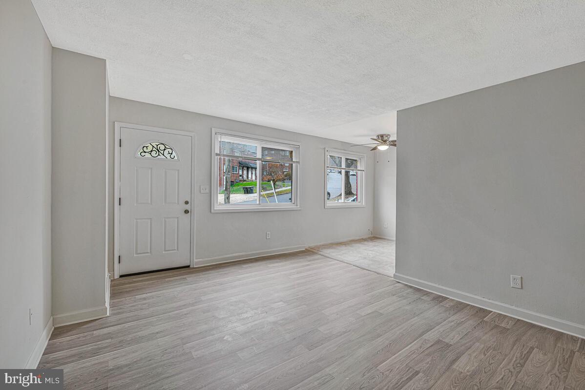 107 Joliet Street Washington, DC 20032 - Photo 7 of 52 an empty room with wooden floor and windows