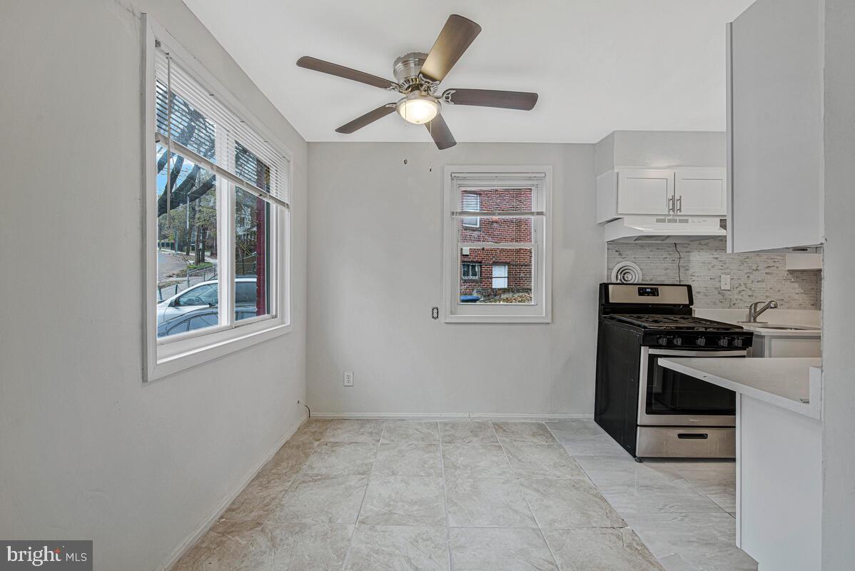 107 Joliet Street Washington, DC 20032 - Photo 8 of 52 a kitchen with stainless steel appliances granite countertop a stove a sink and a refrigerator