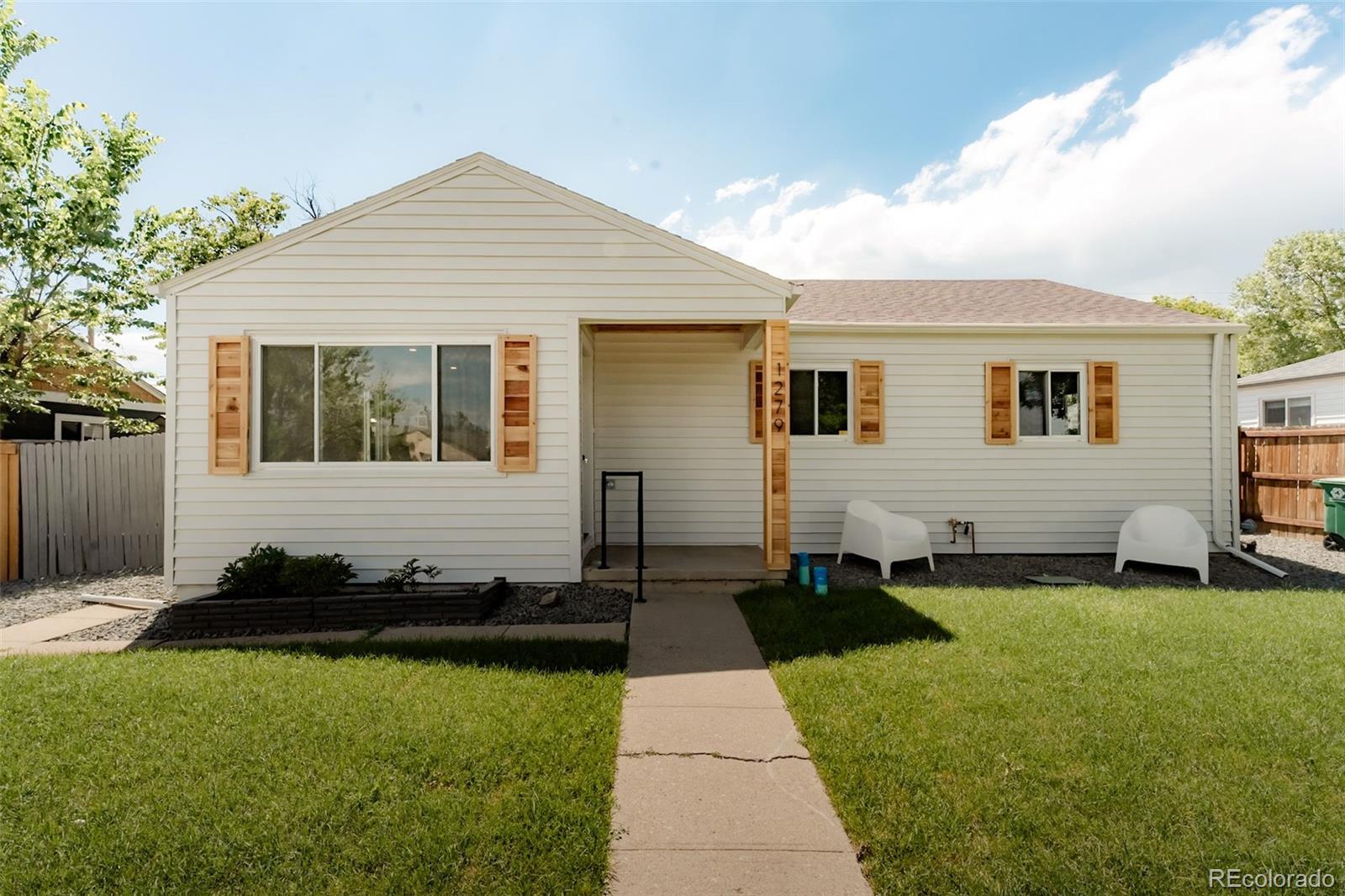 1279 South Raritan Street Denver, CO 80223 - Photo 23 of 25 a front view of a house with a yard