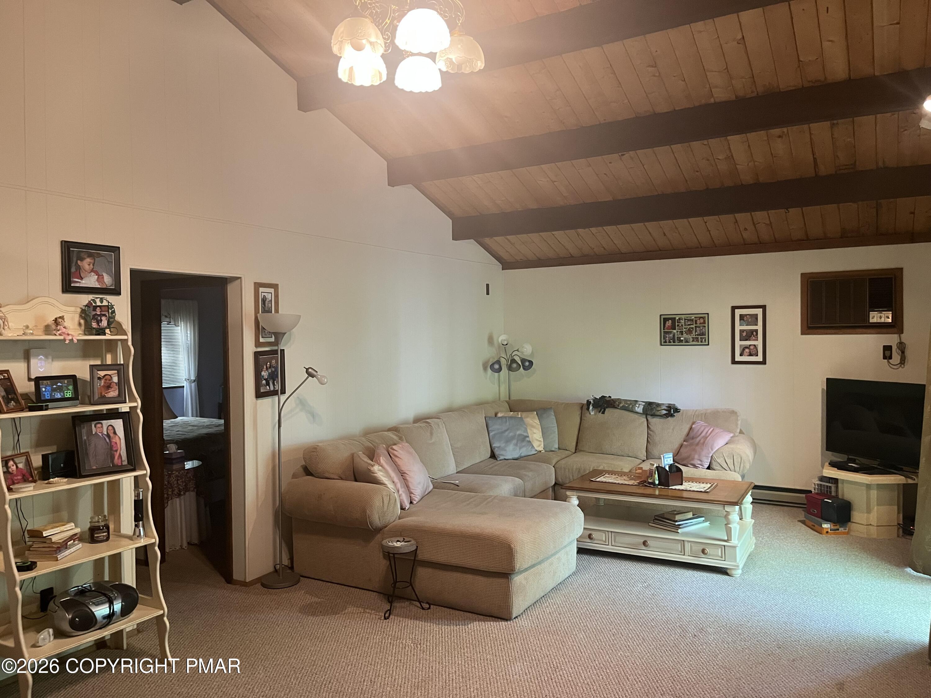 5970 Decker Road Bushkill, PA 18324 - Photo 18 of 26 a living room with furniture a flat screen tv and a bookshelf