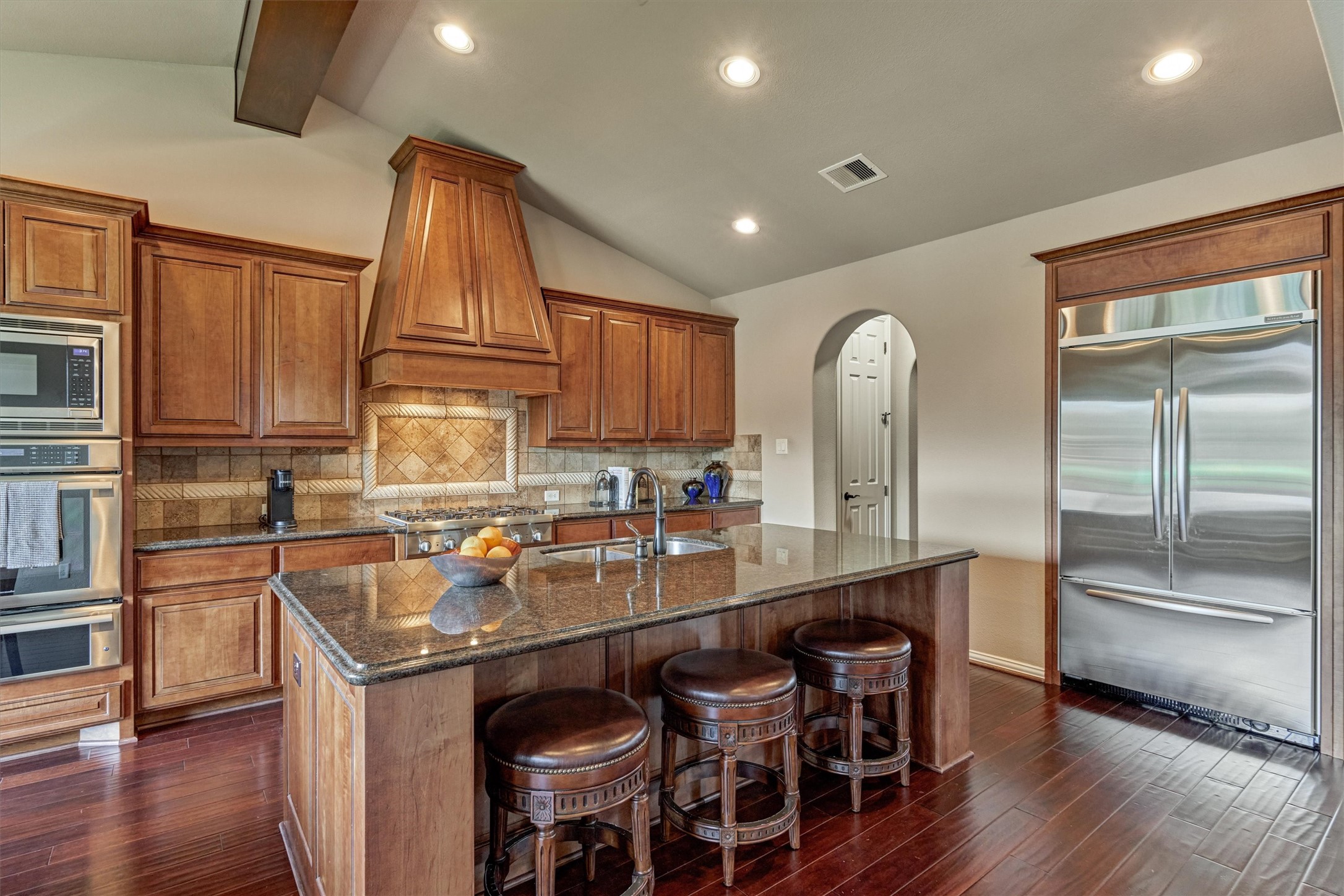 82 East Crystal Canyon Circle The Woodlands, TX 77389 - Photo 10 of 50 This well-appointed chef’s kitchen features stainless steel appliances, including a built-in refrigerator.