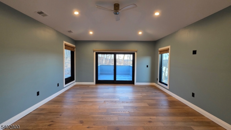 27 Sanders Road Rockaway, NJ 07866 - Photo 13 of 16 a view of an empty room with window and wooden floor